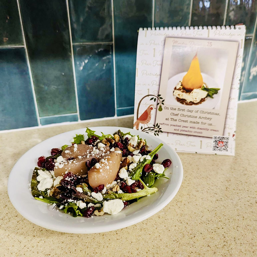 Feast your eyes on a vibrant plate of poached pear salad, elegantly displayed on a counter, promising a delightful culinary experience.