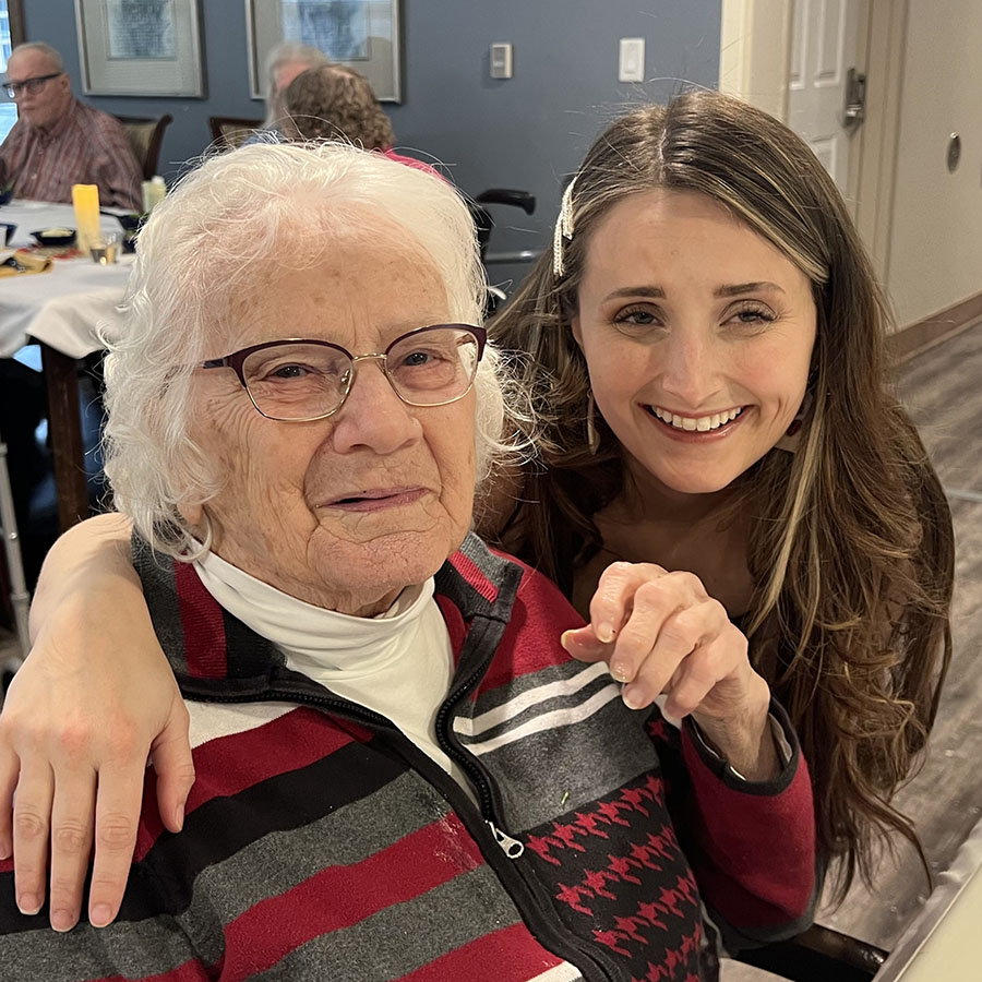 Hannah, the Assistant Executive Director and community senior resident, beaming with joy at a delightful dinner.